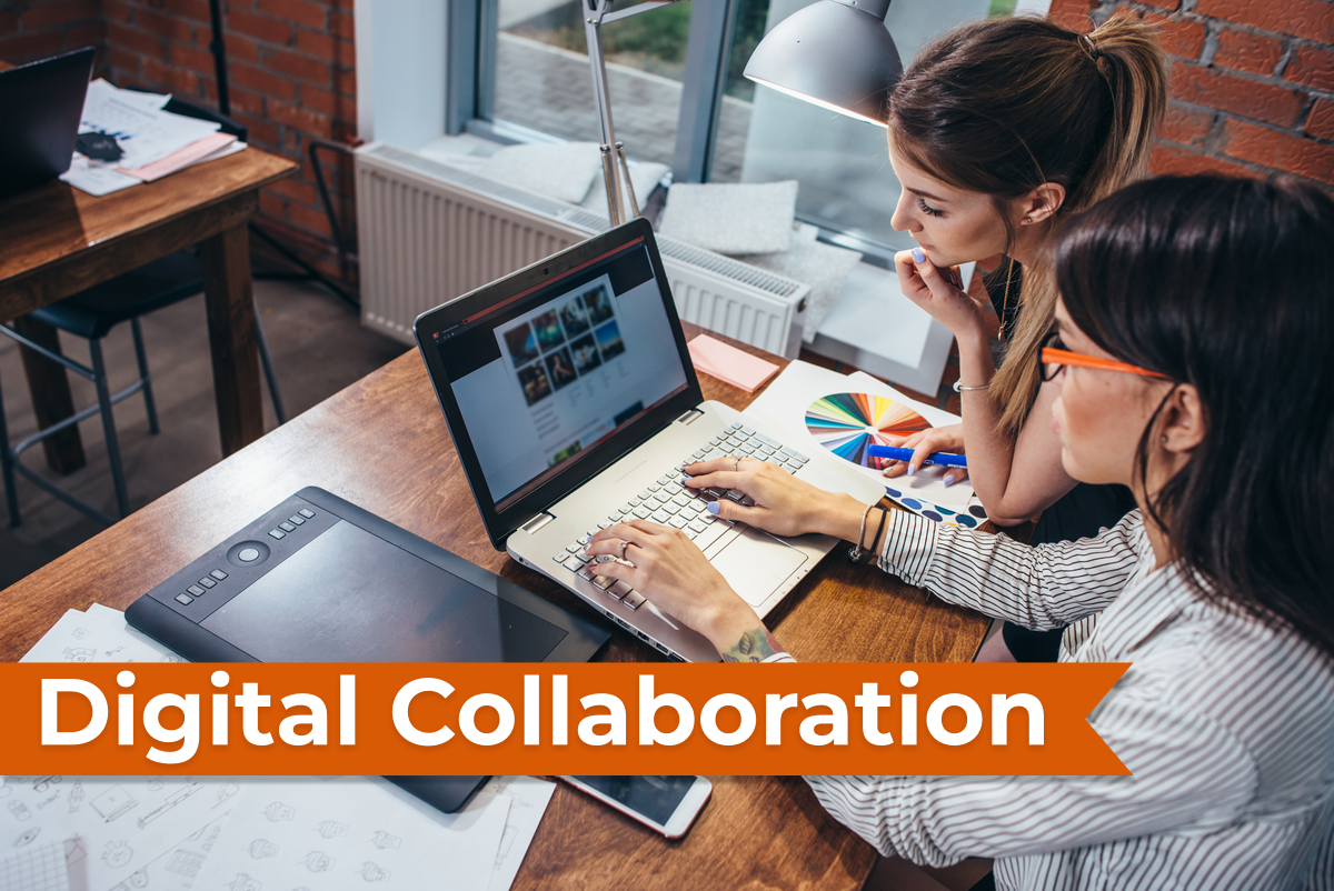 Two people working together on a computer. 